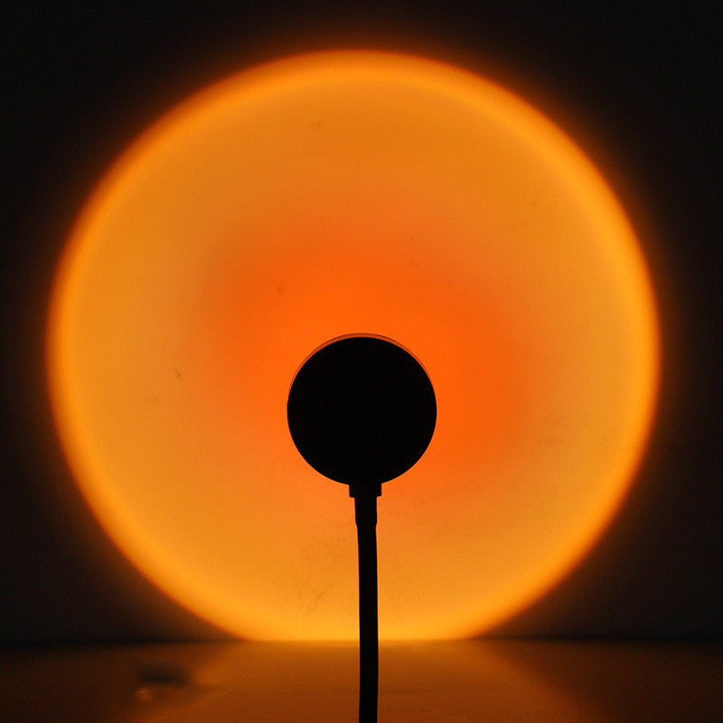 Sunset lamp projecting warm light on a wall