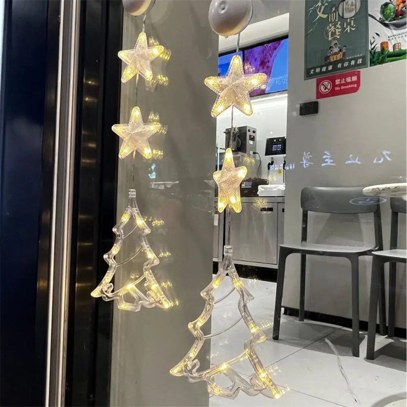 Three warm-white Christmas pendants glowing in window