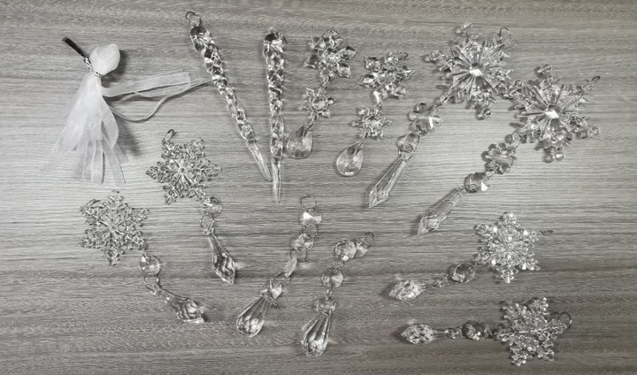 Clear acrylic icicle ornaments hanging on Christmas tree