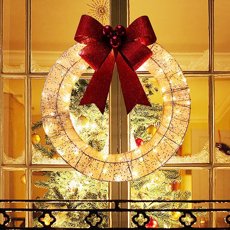 Gold tinsel wreath with lights and red bow