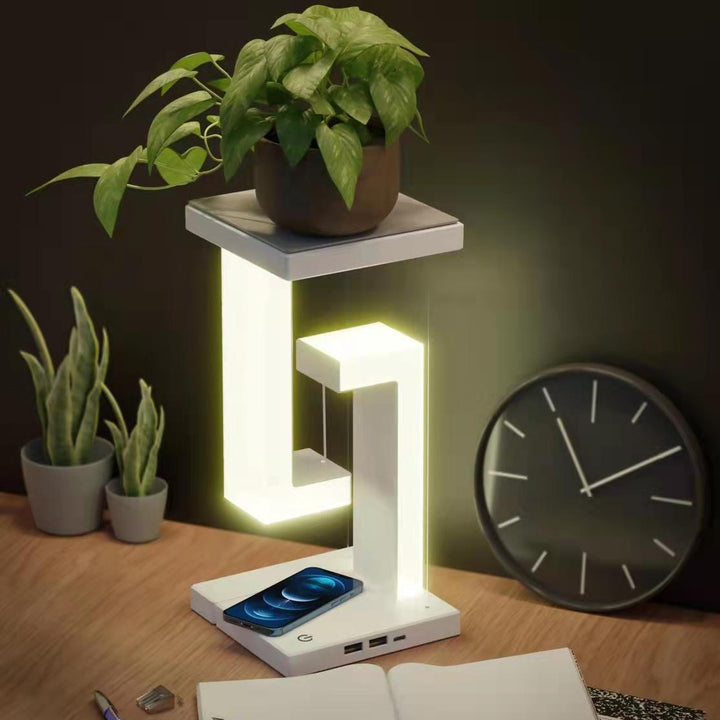 Floating balance lamp with phone on charging base