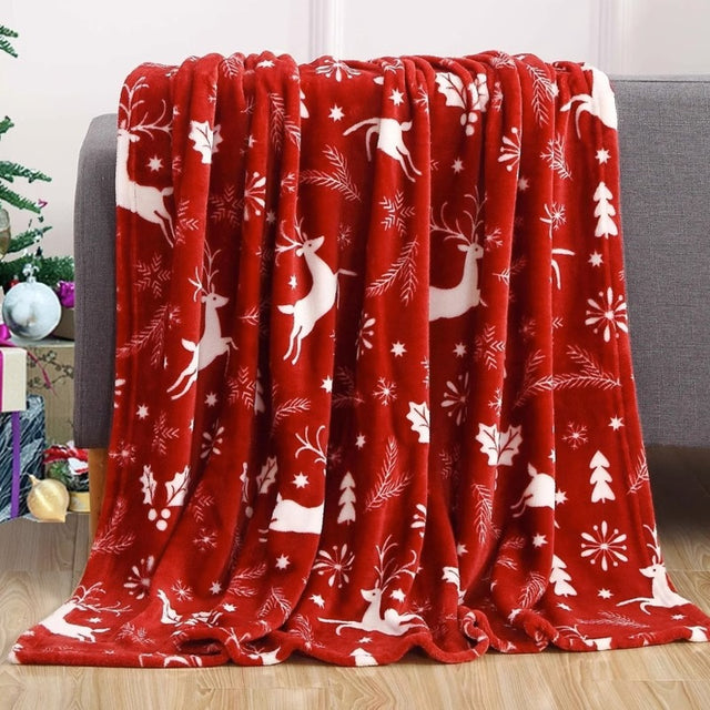 Christmas fleece throw blanket on a sofa