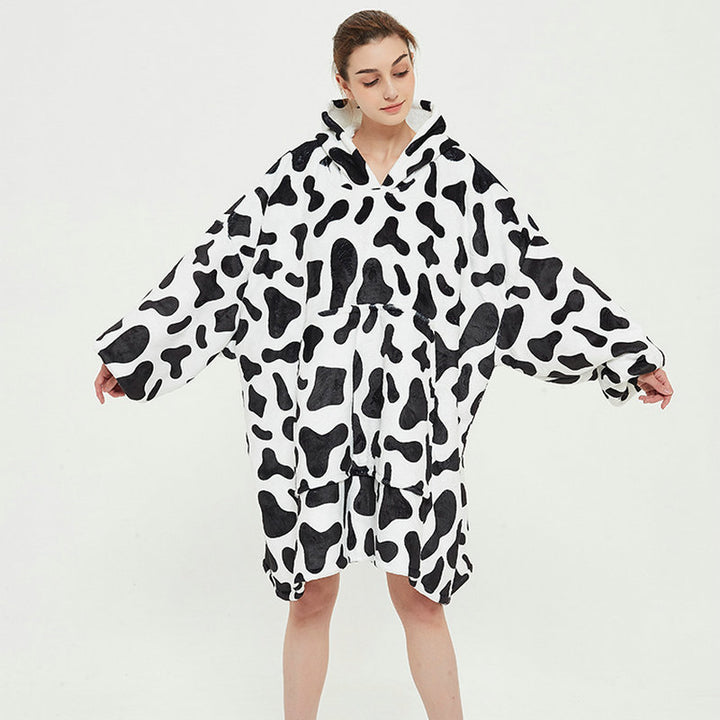 Person in an oversized printed hoodie blanket