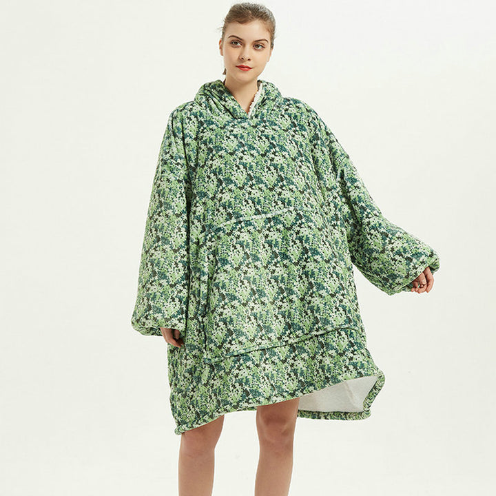Person in an oversized printed hoodie blanket