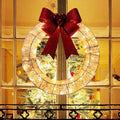 Gold tinsel wreath with lights and red bow