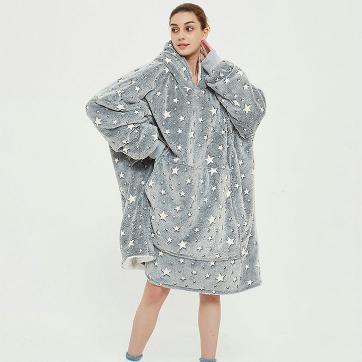 Person in an oversized printed hoodie blanket
