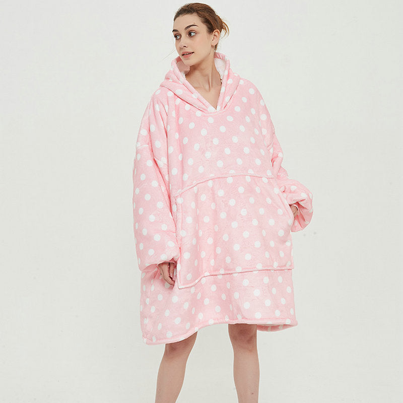 Person in an oversized printed hoodie blanket