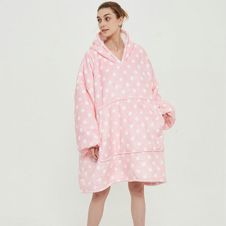 Person in an oversized printed hoodie blanket