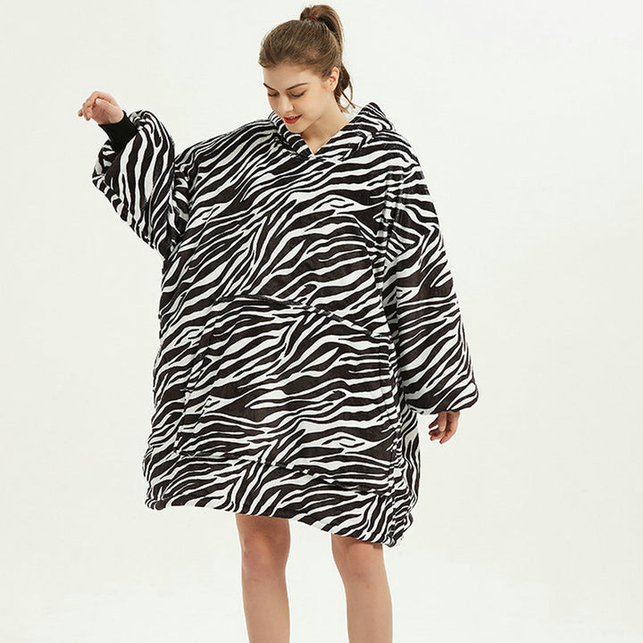 Person in an oversized printed hoodie blanket