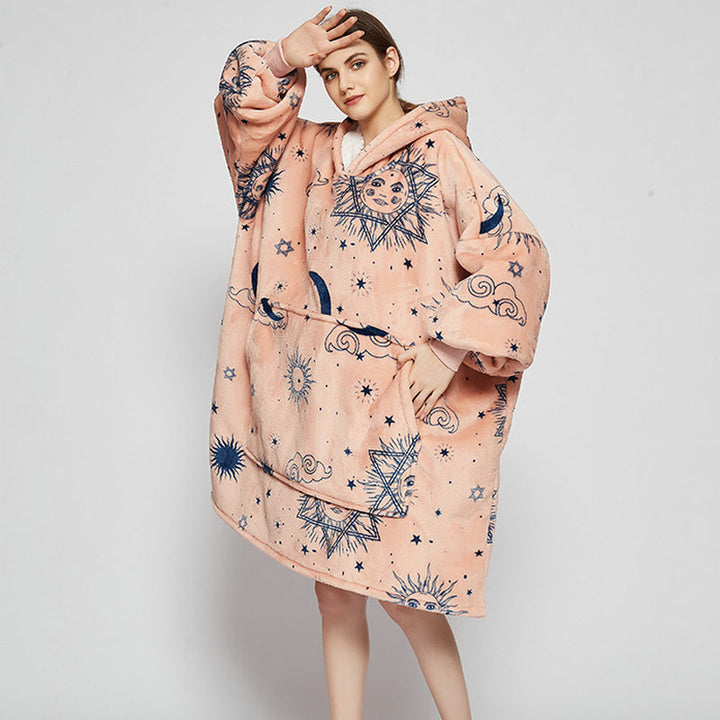 Person in an oversized printed hoodie blanket