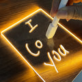 Glowing acrylic message board on wooden base