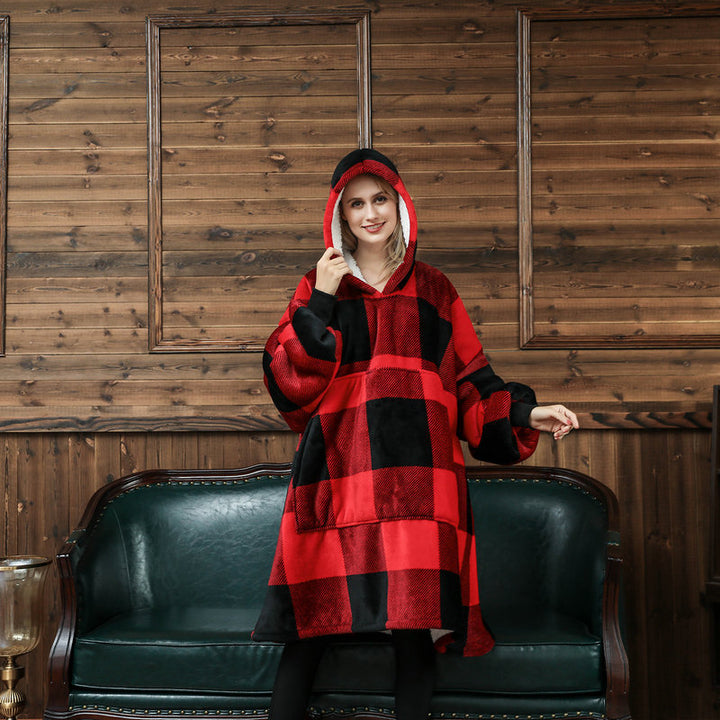 Person in an oversized printed hoodie blanket