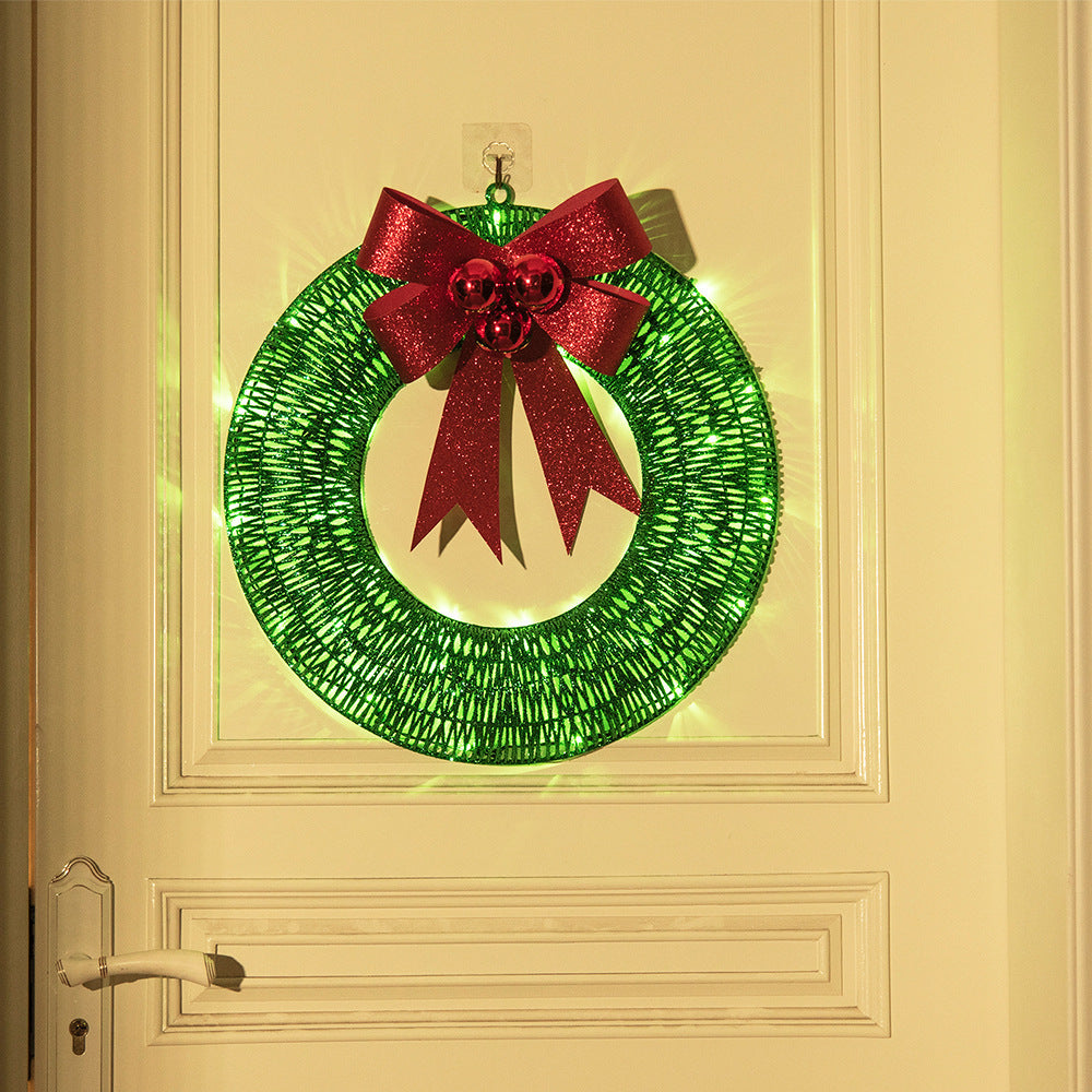 Gold tinsel wreath with lights and red bow