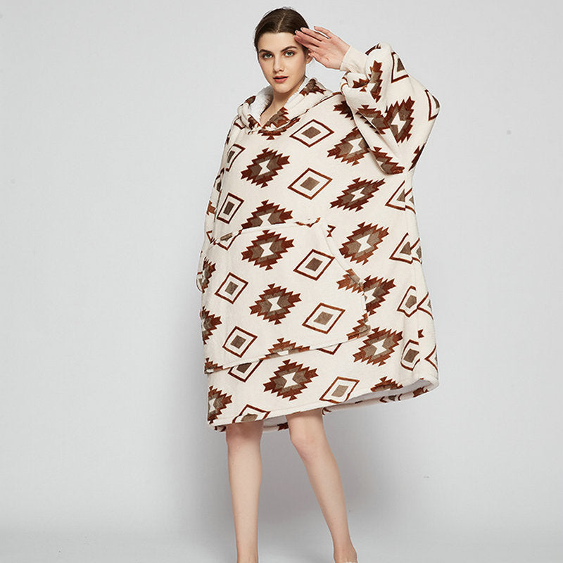 Person in an oversized printed hoodie blanket