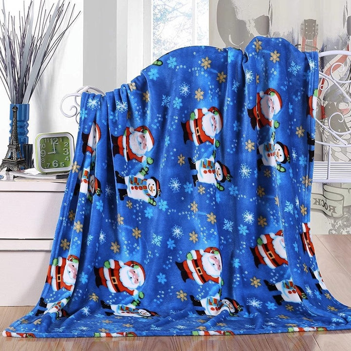 Christmas fleece throw blanket on a sofa