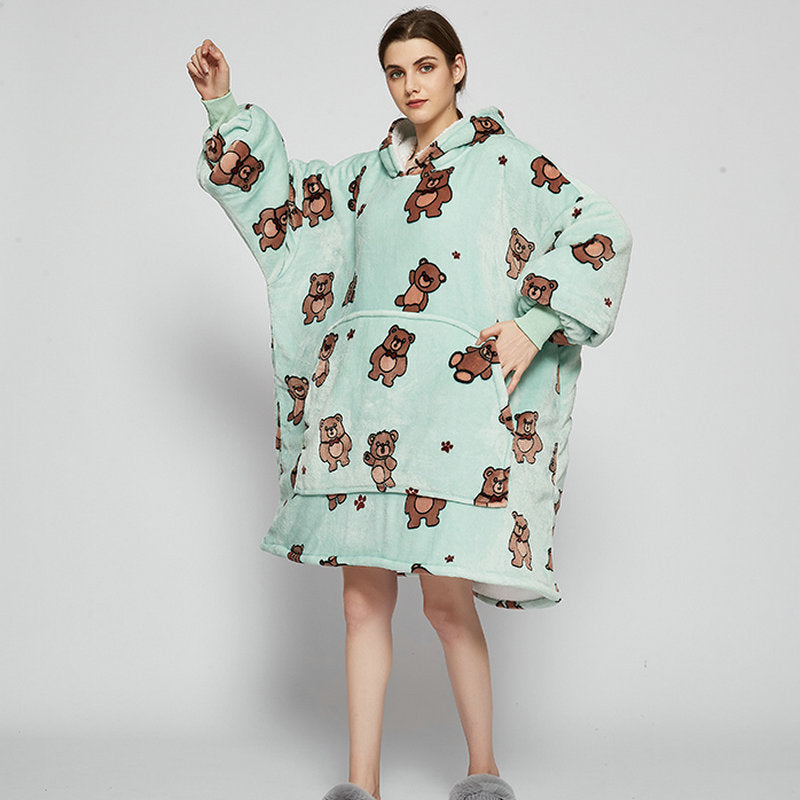 Person in an oversized printed hoodie blanket