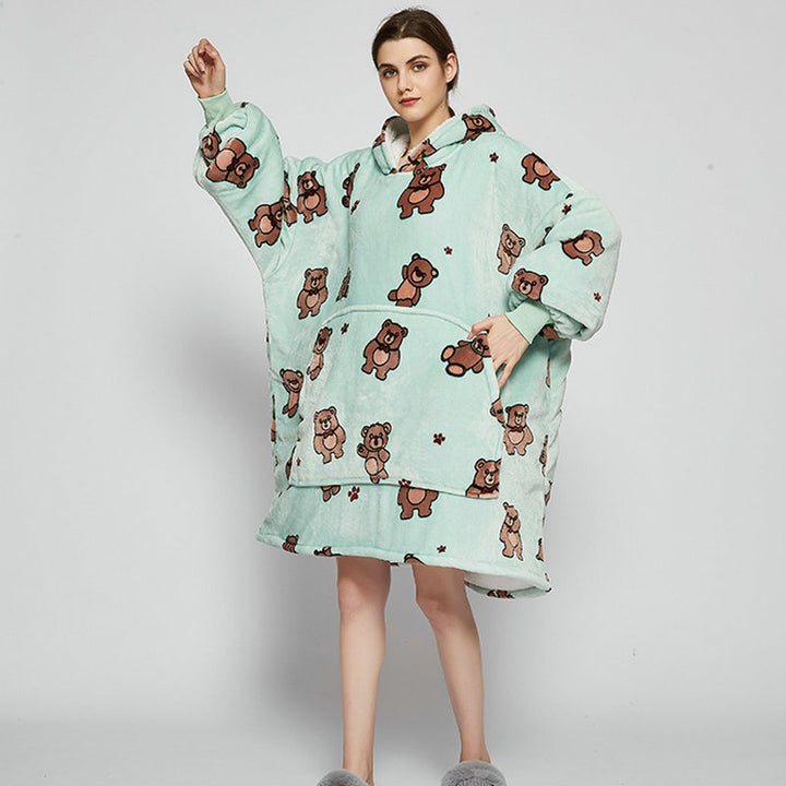 Person in an oversized printed hoodie blanket