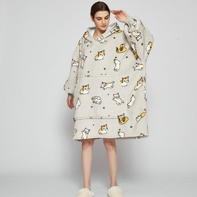 Person in an oversized printed hoodie blanket