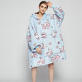 Person in an oversized printed hoodie blanket