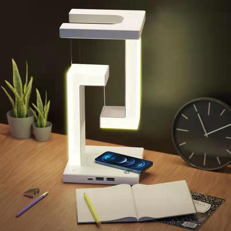 Floating balance lamp with phone on charging base